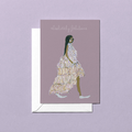 Greeting card with fashion illustration of a woman with black hair in a white feather and white shoes dress on a purple background