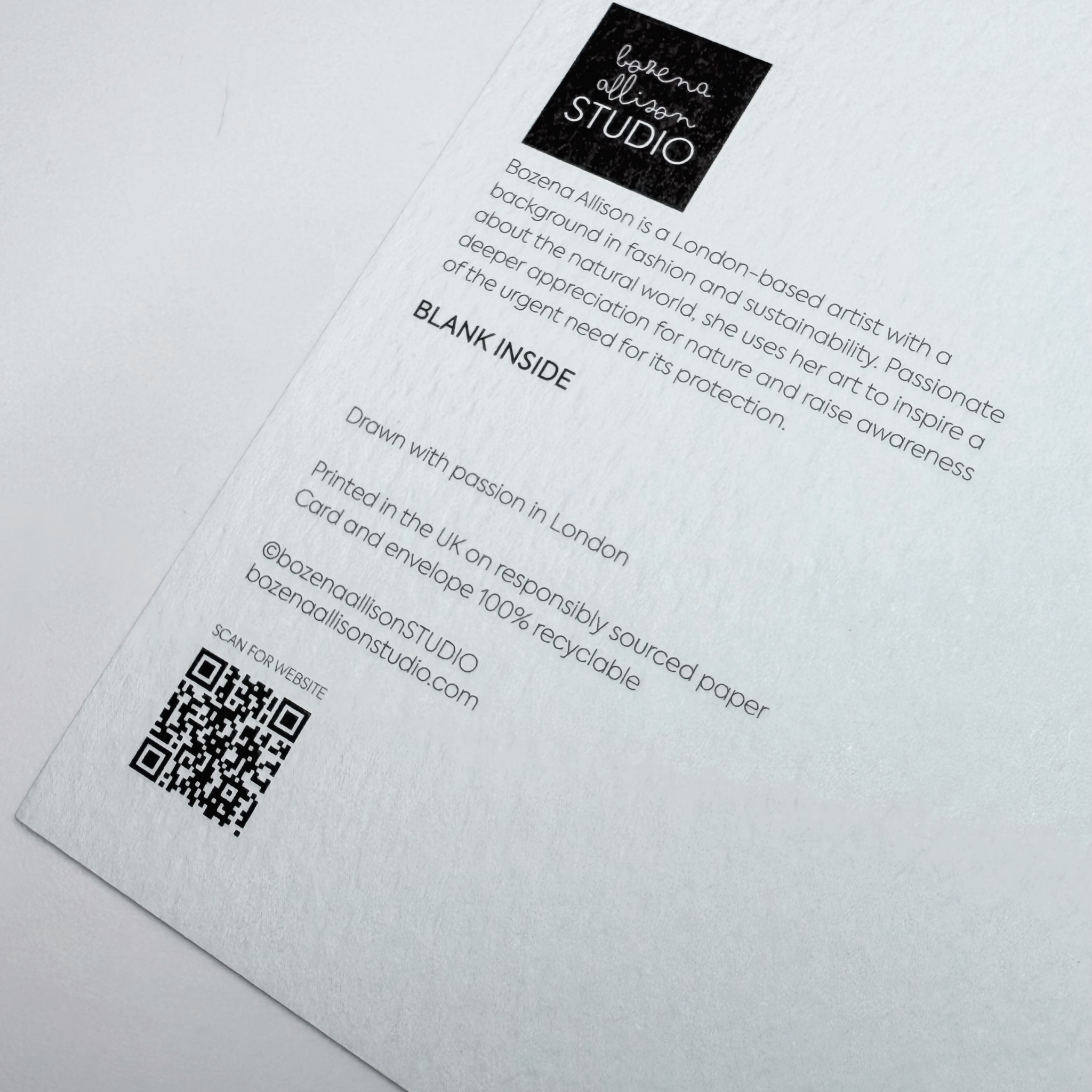 Back of a card with text and a QR code on a white background