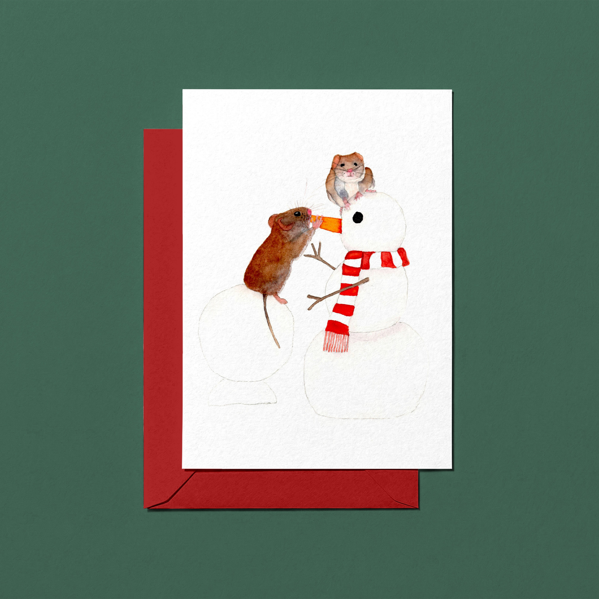 Christmas greeting card with two mice on a snowman and a red envelope on a green background