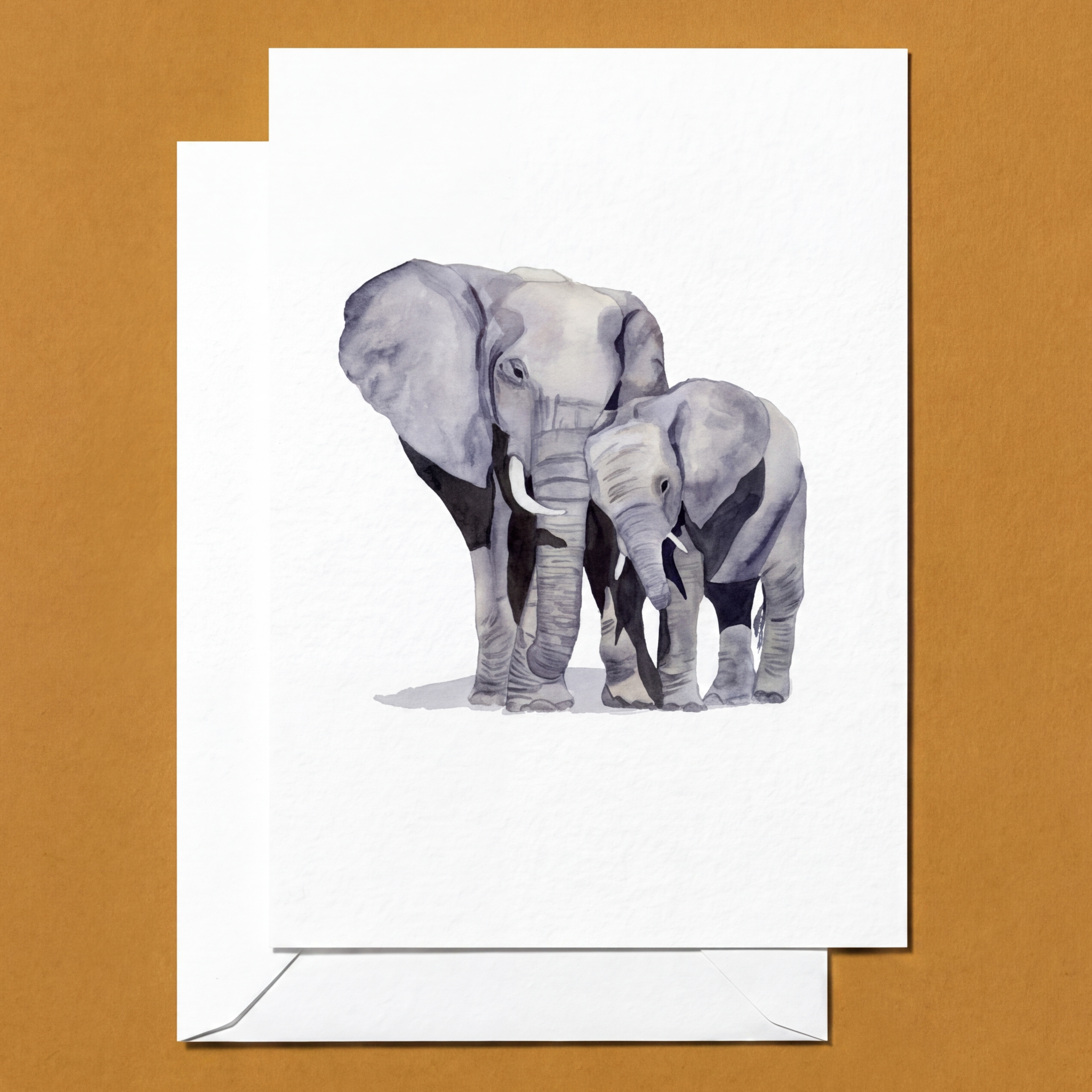 Greeting card with illustration of two elephants on a white background, placed on a brown surface.