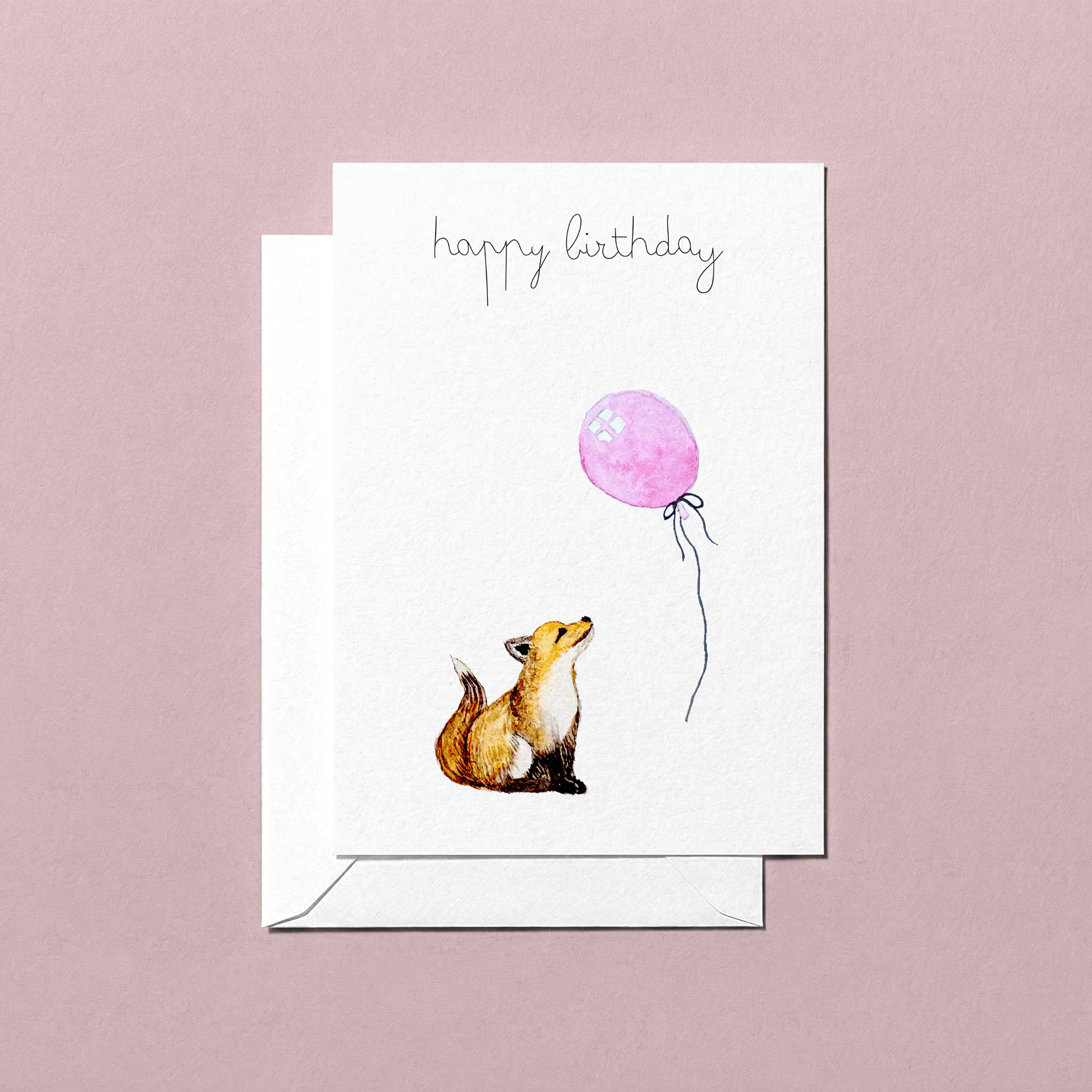 Greeting card with a foxl looking up at a pink balloon and 'happy birthday' text on a pink background