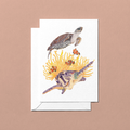 Greeting card with two watercolour hand-illustrated sea turtles swimming among coral 
