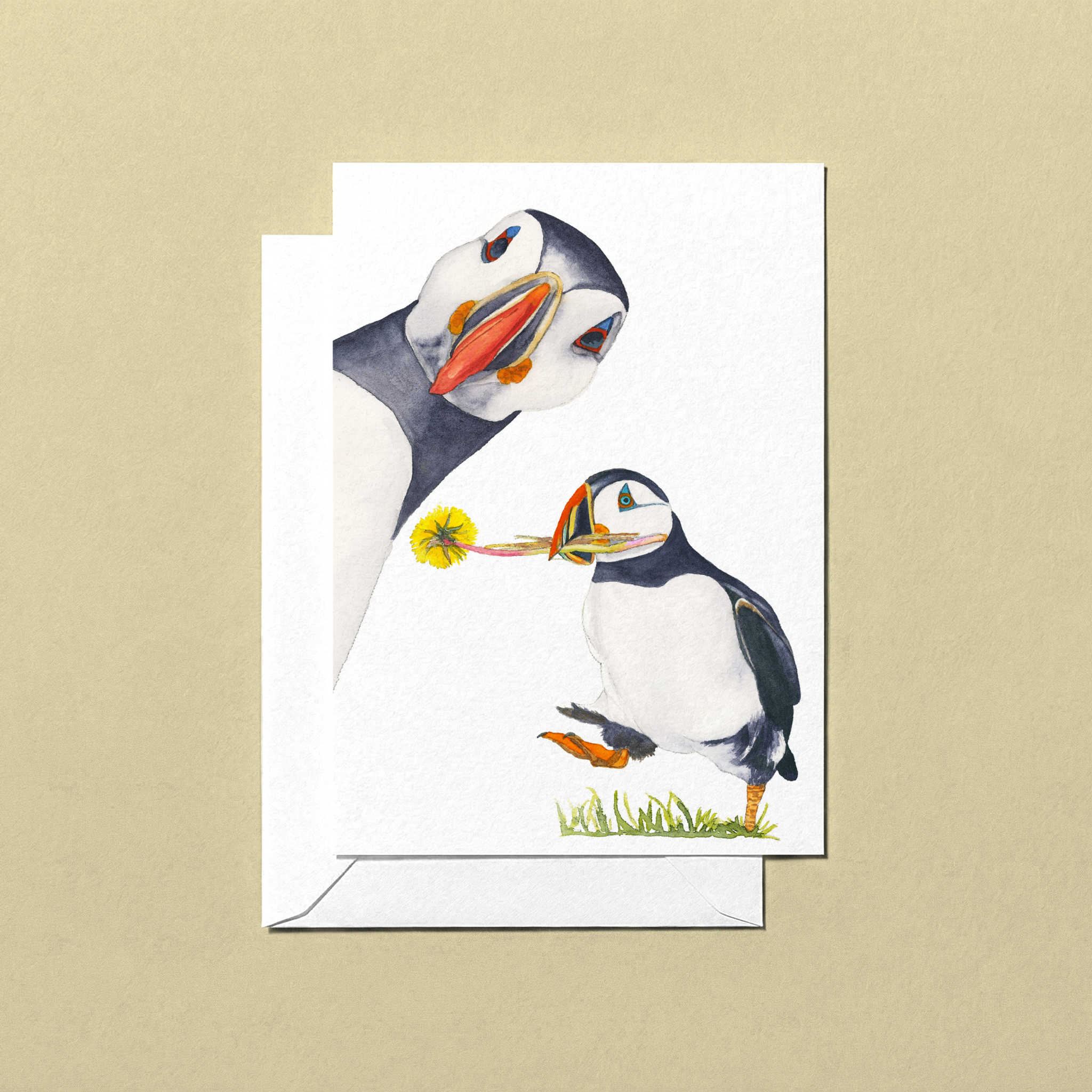 Greeting card with two puffins on a beige background