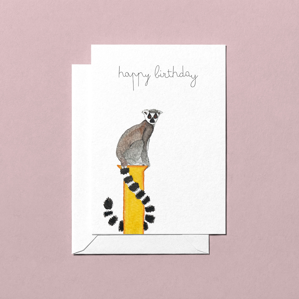 Greeting card with a lemur watercolour illustration and 'happy birthday' text on a pink background