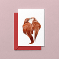 Card with two otters embracing on a white background, featuring a red envelope.