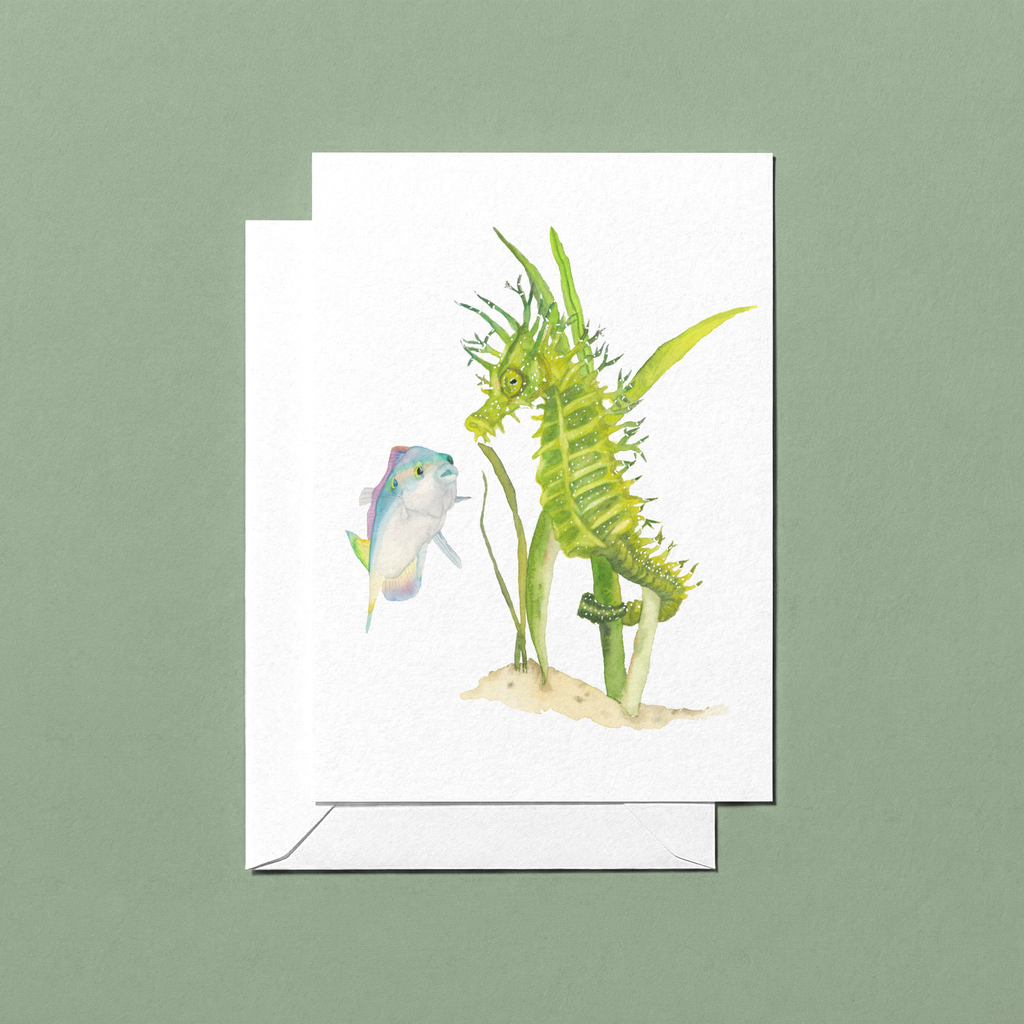 Watercolour hand-illustrated greeting card with a green seahorse holding onto sea grass