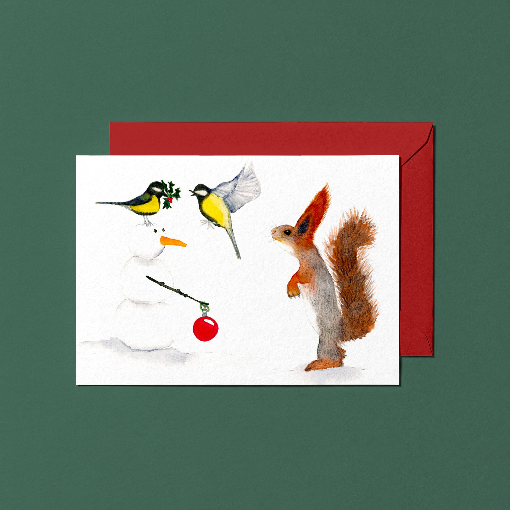 Christmas card with a squirrel, birds, and snowmen on a white background with a red envelope.