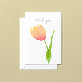 Greeting card with a pink tulip watercolour illustration and 'thank you' text on a beige background