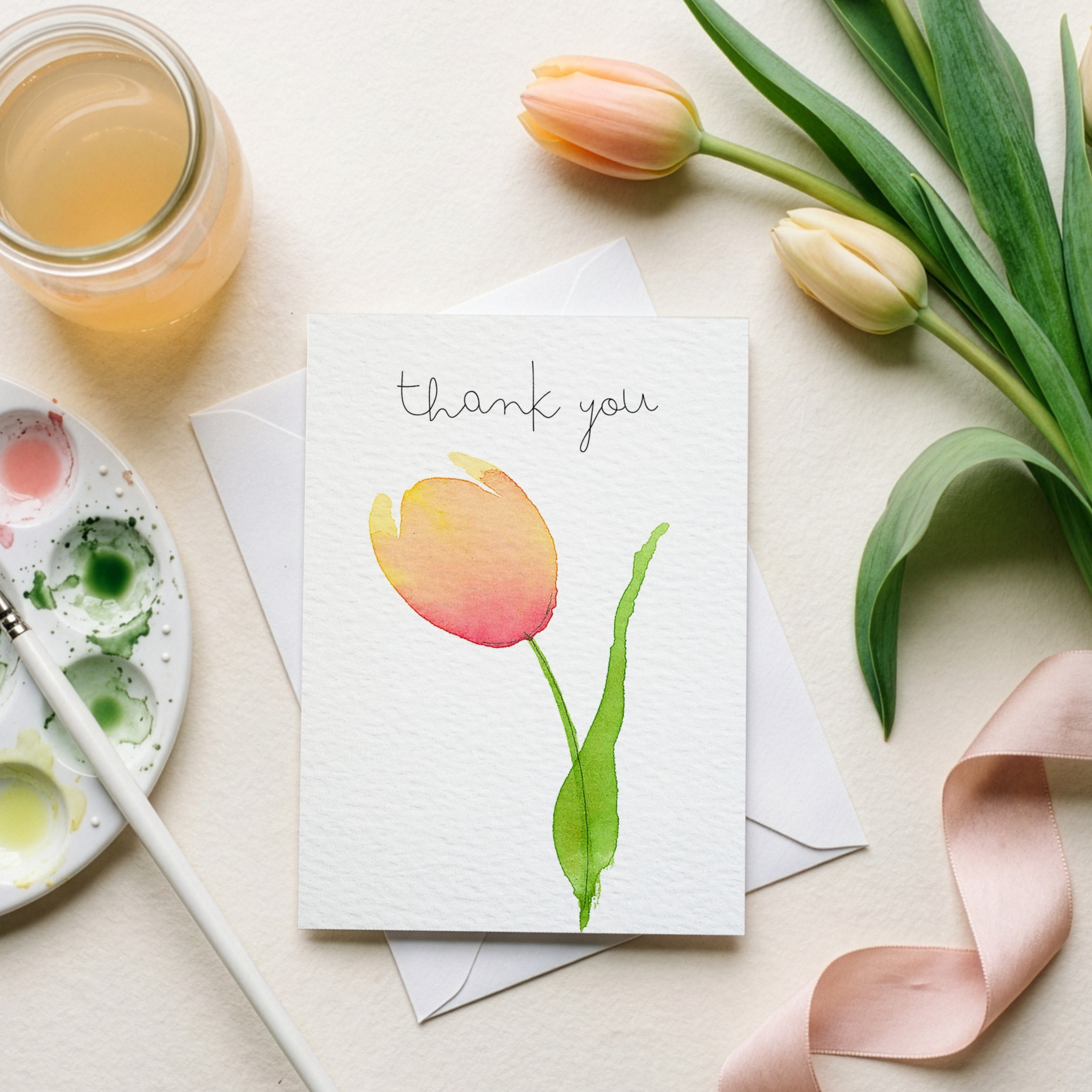 Greeting card with tulip watercolour illustration and 'thank you' text, surrounded by tulips. 